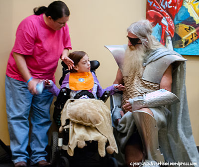 I was waiting for my friends when I saw this older man dressed as Odin from Thor! He was so sweet to this woman (who I found out was the aunt) of this cute little girl with Cerebral Palsy! I showed this photo to the aunt later and emailed her it, I hope they had fun at the con! They were there with others to see Gerard Way and have fun etc. 